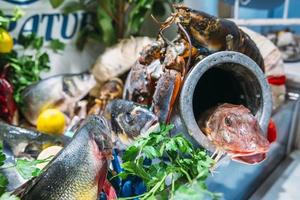 Seafood platter with a variety of types of fish on display on ice at a restaurant photo