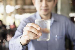 Man drink fresh cold pure water in glass photo