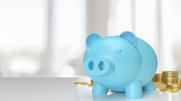 blue piggy bank on white table and gold coins for saving or business concept 3d rendering photo