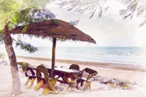 empty chairs and wooden umbrellas on a sandy beach ,watercolor digital painting style photo