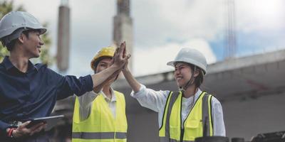 Asian engineers and architects at the construction site teamwork engineer work togetheSuccessful teamwork housing project photo