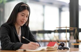 Business and lawyers discussing contract papers with brass scale on desk in office. Law, legal services, advice, justice and law concept photo