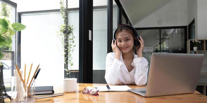 close up of Student learning online class by using laptop computer and writing notebook at workplace, E learning and online working concept. photo