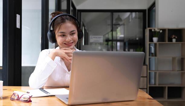 close up of Student learning online class by using laptop computer and writing notebook at workplace, E learning and online working concept. photo