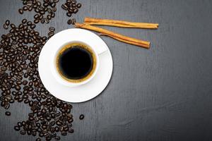 Espresso coffee morning homemade has bean cinnamon dark on wood table.