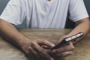 echnology concept social media man using smart phon access online media Through the Internet, there is marketing to answer customer chats. by working at home photo
