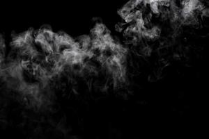 Abstract powder or smoke effect isolated on black background photo