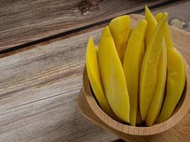 pickled mango Thailand   in bowl on wood table for food content. photo