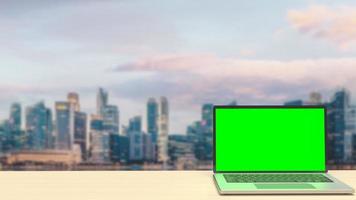 The notebook display green screen on rooftop building  for present concept 3d rendering photo