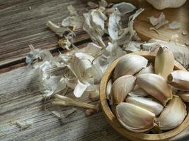 The garlic on wood table for food or cooking concept. photo