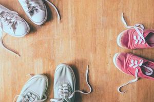 Top view of Colorful sneakers on the wooden table background. photo