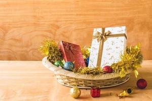 Gift boxes with Christmas decoration on wooden table background. photo