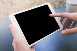 Close up of Male hands using Tablet touch computer gadget on the desk photo