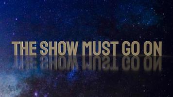 gold text the show must go on for present background photo