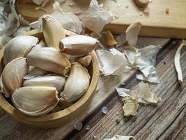 The garlic on wood table for food or cooking concept. photo