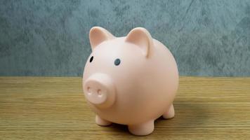 A piggy bank on wood table for  Finance or saving money business content. photo