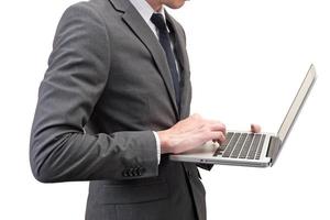 Businessman holding laptop isolated on white background. photo