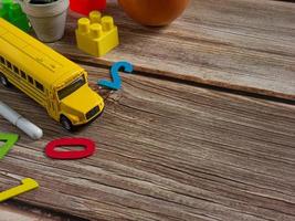 school bus on wood table for education or back to school  concept photo