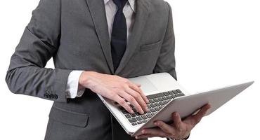 Businessman holding laptop isolated on white background. photo