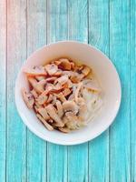 Mushrooms with noodles. Sun flare. Wooden table. photo