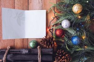 Top view of Card with Christmas decoration on wooden table background photo