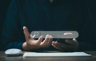 The concept of using technology to search for information, a man's hand is using a smartphone to search for information on social media via the Internet online. photo