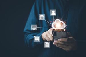 Cloud technology data storag concept, man's hand using a smartphone to use, backup, store in Cloud Data storag as an online connection. Files can be retrieved at any time. convenient and safe photo