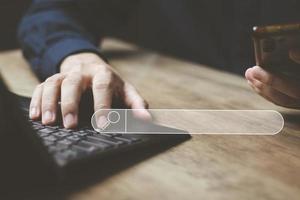 The concept of using technology to search for information, a man's hand is using a smartphone to search for information on social media via the Internet online. photo