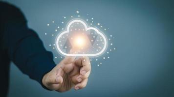 Cloud computing concept A business man holds a cloud storage mockup to demonstrate keeping the data safe.. photo