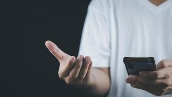 echnology concept social media man using smart phon access online media Through the Internet, there is marketing to answer customer chats. by working at home photo