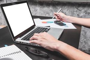 Male hands working on laptop with document. Concepts for business analysis, consulting, teamwork, project management, financial report and strategy. photo