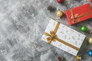 Top view of Gift boxes with Christmas decoration on gray grunge background. photo