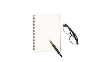 Top view of Notebook with pen and glasses on white background. photo