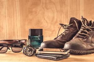 Male accessories, clothes and gadgets on the wooden table. photo