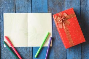 Top view of Gift boxes with card on wooden table background. photo