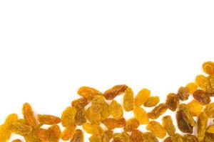 Yellow raisins on white background. photo