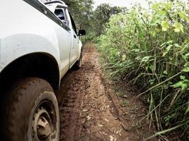 The car's wheels on the dirt road. photo