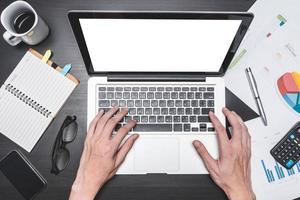 Top view of workplace with Laptop and document. Concepts for business analysis, consulting, teamwork, project management, financial report and strategy. photo
