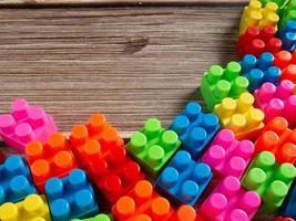 Toy brick on wood table photo