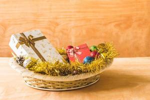 Gift boxes with Christmas decoration on wooden table background. photo