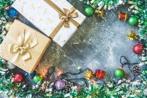 Top view of Gift boxes with Christmas decoration on gray grunge background. photo