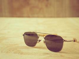 Sunglasses on the wooden table. photo