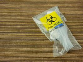 The  Antigen Test Kit in biohazard garbage for medical or sci concept photo