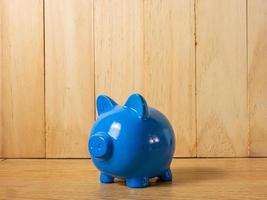 The piggy bank on wood table for saving or business background concept photo