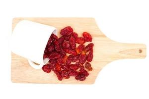 Dried Tomatoes with cup  on wooden tray. photo