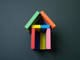 The multicolour home toy on black background for property content photo