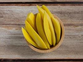 pickled mango Thailand   in bowl on wood table for food content. photo