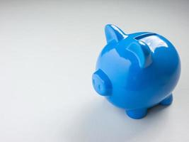 The blue piggy bank on white background for saving or business concept photo