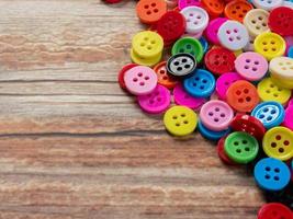 Buttons multi color on wood table for diy or handcrafted  concept. photo