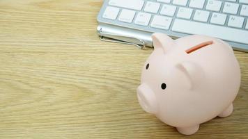 A piggy bank on wood table for  Finance or saving money business content. photo